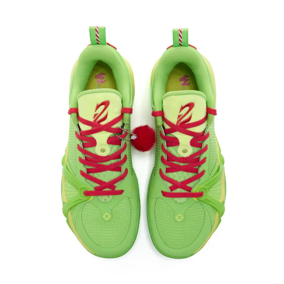 Pair of green sneakers with red laces on a white background